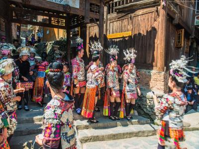 Girls wear short skirts at Xinqiao Miao Village